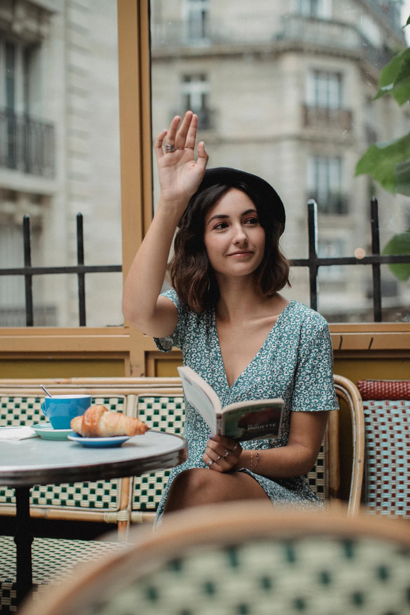 Woman reading at an outdoor Paris café