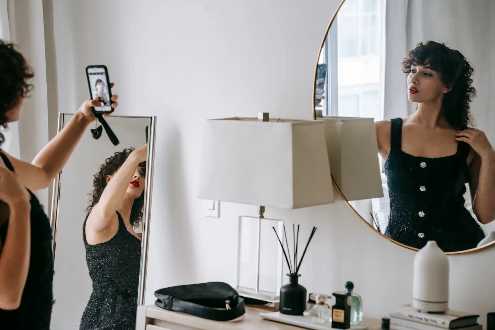 Woman taking a phone selfie in a bright room