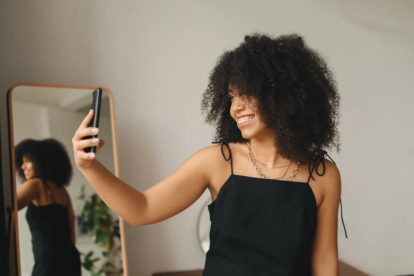 Smiling woman taking an everyday phone selfie